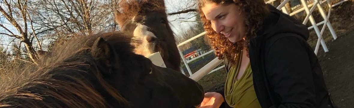 Amanda connects with an Icelandic horse in Iceland